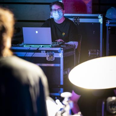 ethan working behind the scenes at a lighting desk